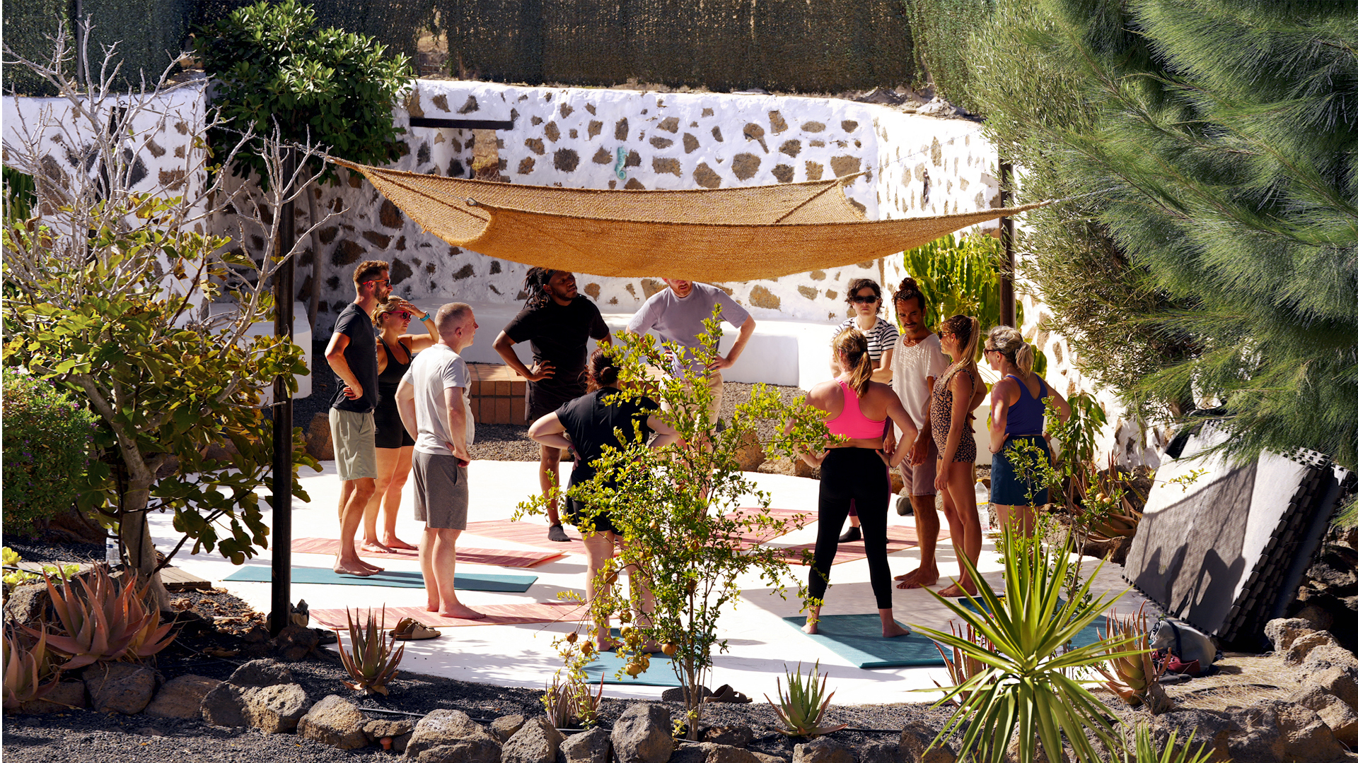 Yoga group practising outdoors under a light canopy at Villa Azul, Fuerteventura