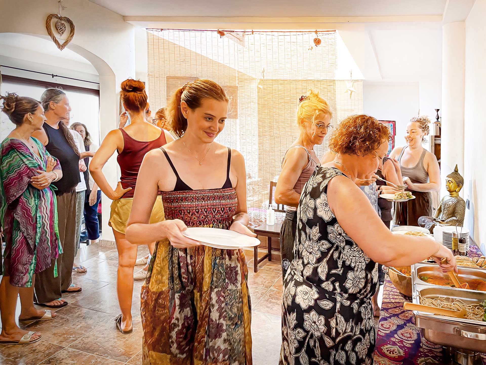 Group of women chatting and serving themselves at the buffet at Villa Azul, Fuerteventura