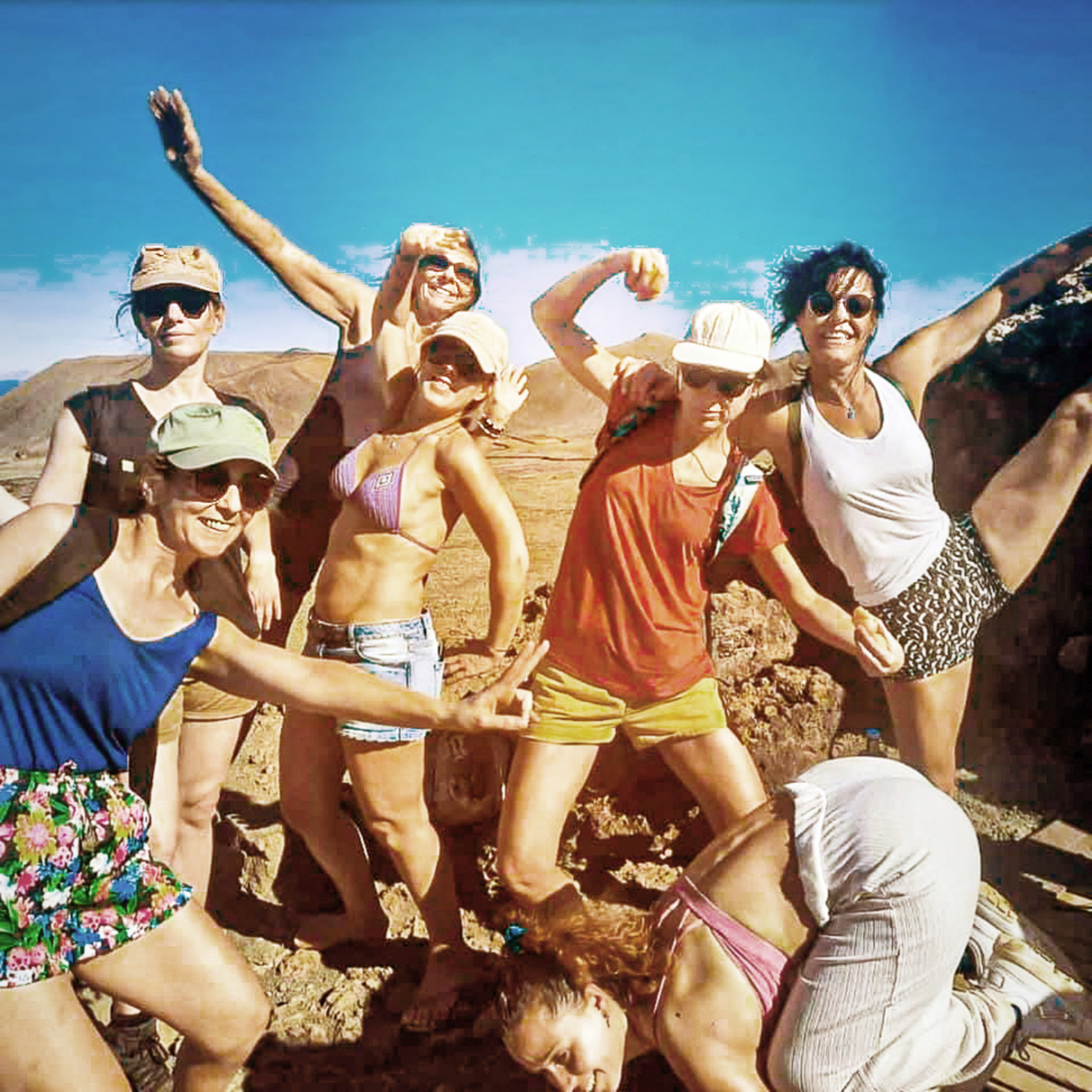 Seven women laughing and posing together during a wellness holiday in Fuerteventura